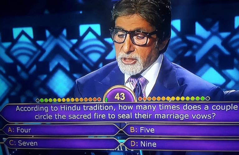 Ques : According to Hindu tradition, how many times does a couple circle the sacred fire to seal their marriage vows?